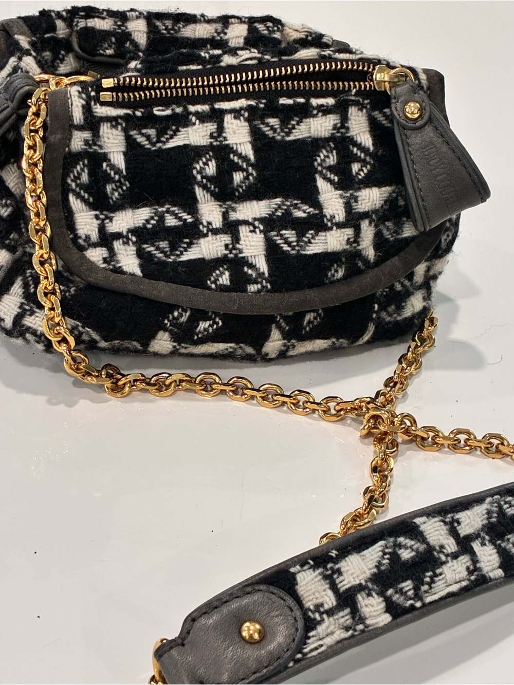 Juicy Couture-Vintage herringbone pattern fabric with branded zipper pulls.